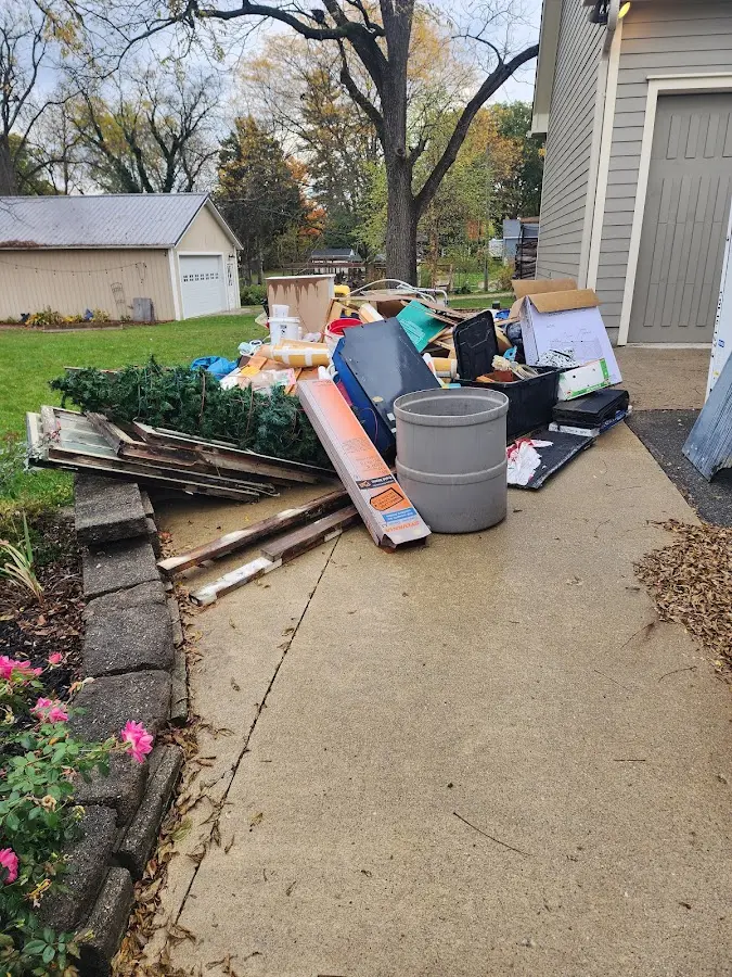 Dumpster being loaded with debris for 3 Yard Dumpster Rental in Rochester